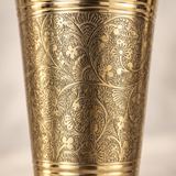 Macro detail of Mughal-style engraving on brass tumbler
