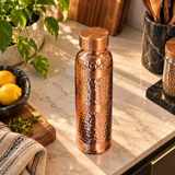 Hammered ring-neck copper bottle elevated angle lifestyle view