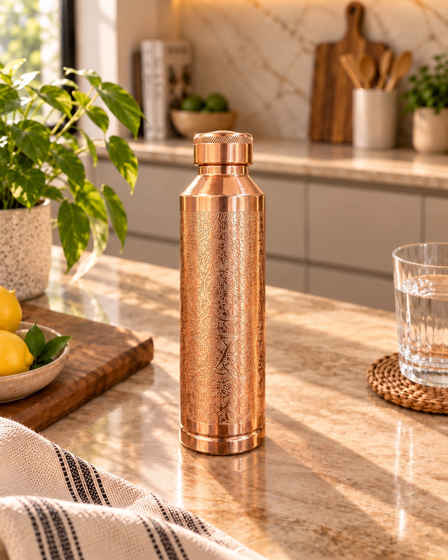 Heritage Floral Engraved Copper Water Bottle in warm kitchen setting