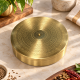 Closed engraved brass masala dabba with decorative lid