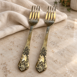 Ornate fork set of two — close view of decorative handles