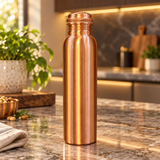 Slim copper water bottle standing in a warm shallow depth of field kitchen scene