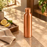 Plain copper water bottle matte finish in warm sunlit lifestyle setting